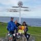 Toby standing by John O'Groats sign