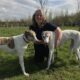 Volunteer jackie with two greyhounds